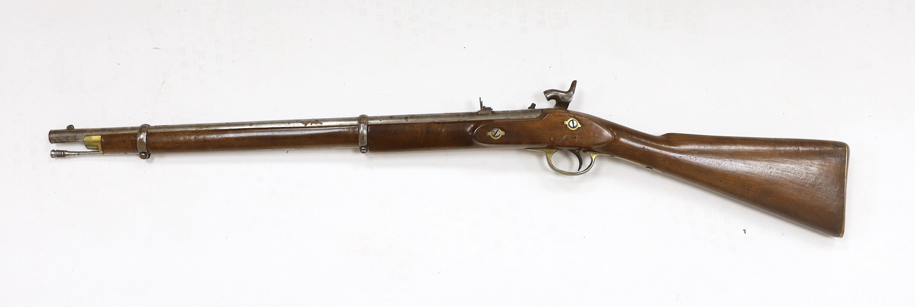 A two band percussion Military carbine of Indian use, regulation brass mounts, fold leaf rear sight, regulation brass mount, lock with Indian marks and also crowned VR, barrel 66.2cm